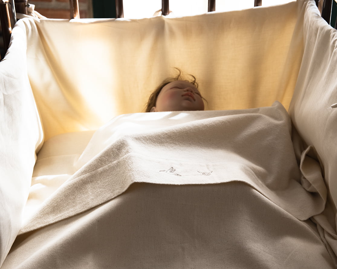 Alt=”Ropa de cuna de bebe”.